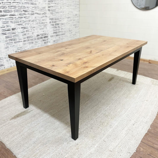 Pictured with a 6' L x 42" W Rustic Alder top stained Weathered Oak and a Black painted base.
