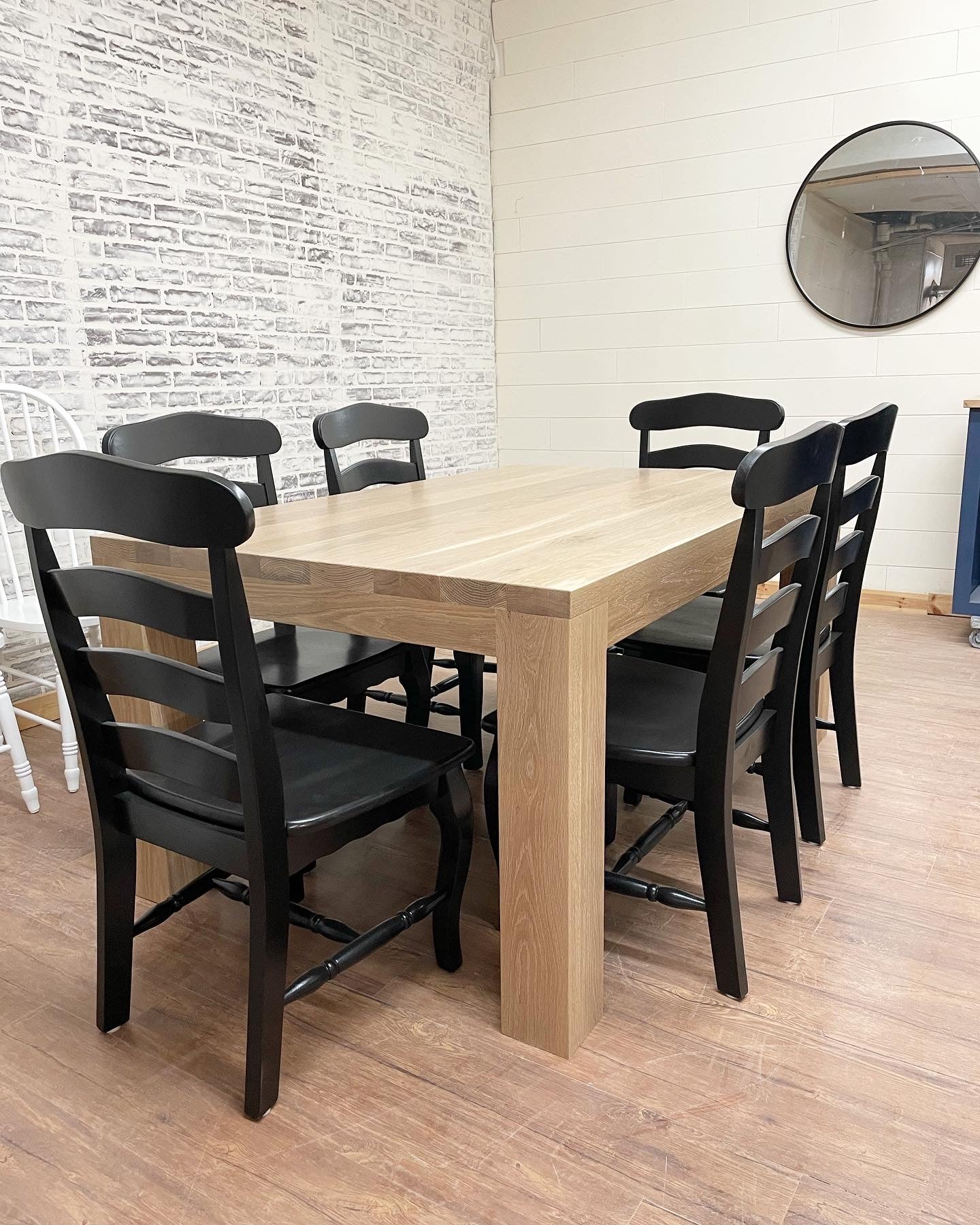 Pictured is a 5.5' L x 42" W White Oak table with Pickled Oak stain. Pictured are 6 French Country Chairs painted Black.