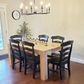 Pictured is a 5.5' L x 42" W White Oak table with Pickled Oak stain. Pictured are 6 French Country Chairs painted Black.