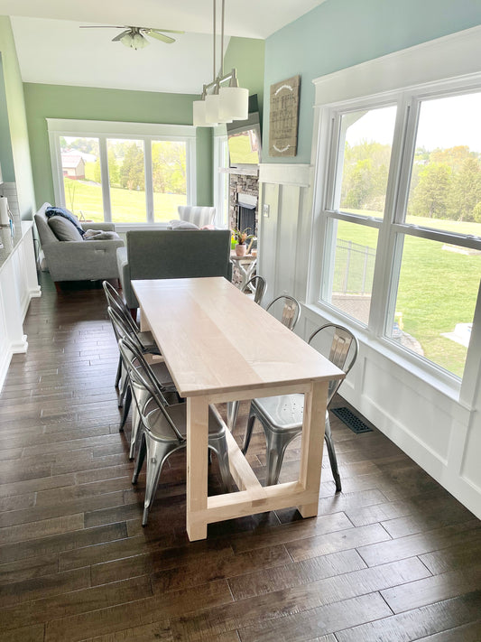 Pictured is a 7' L x 36" W Hard Maple table with a Natural Finish. Pictured is 6 Metal Chairs in a Gun Finish.