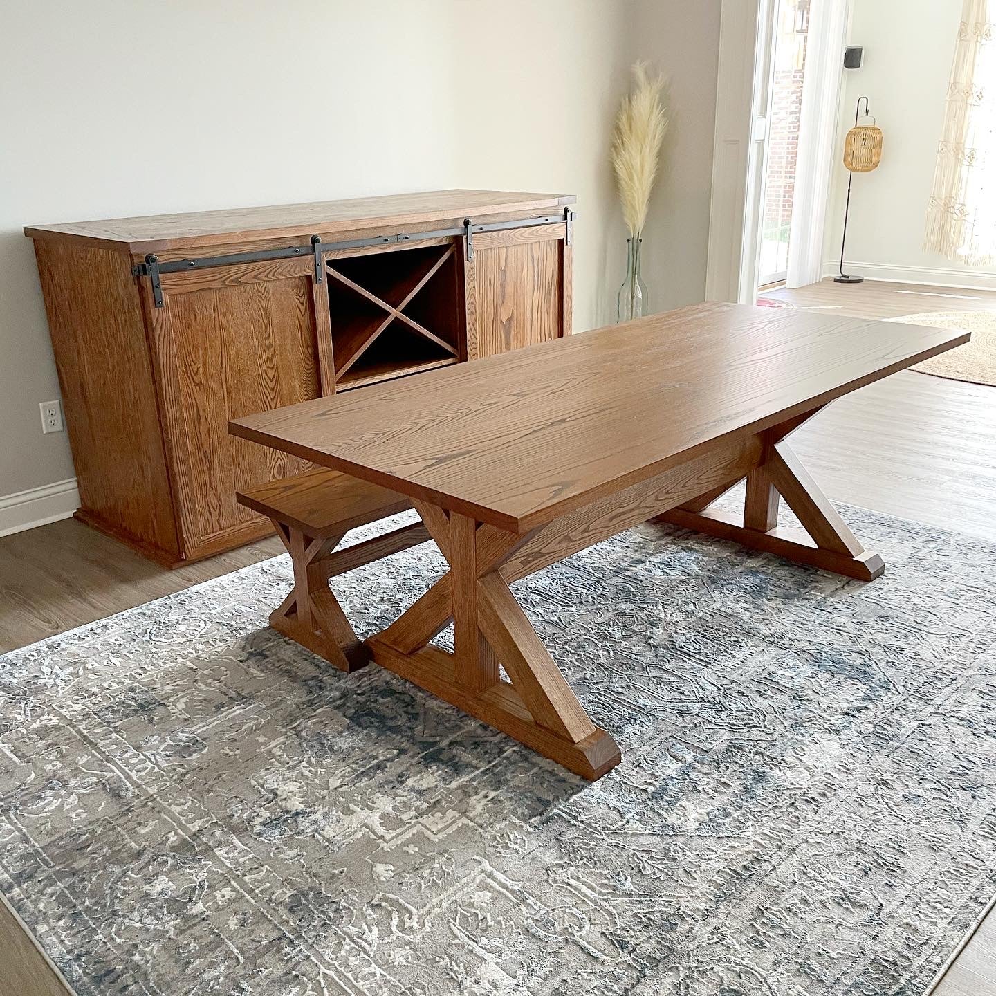 Pictured with a 7' L x 42" W Red Oak table stained Honey. Pictured with a Matching Bench. Pictured with a 6' L x 34.5" T x 20" D Solid Red Oak Sliding Barn Door Console with two X's for wine rack storage .