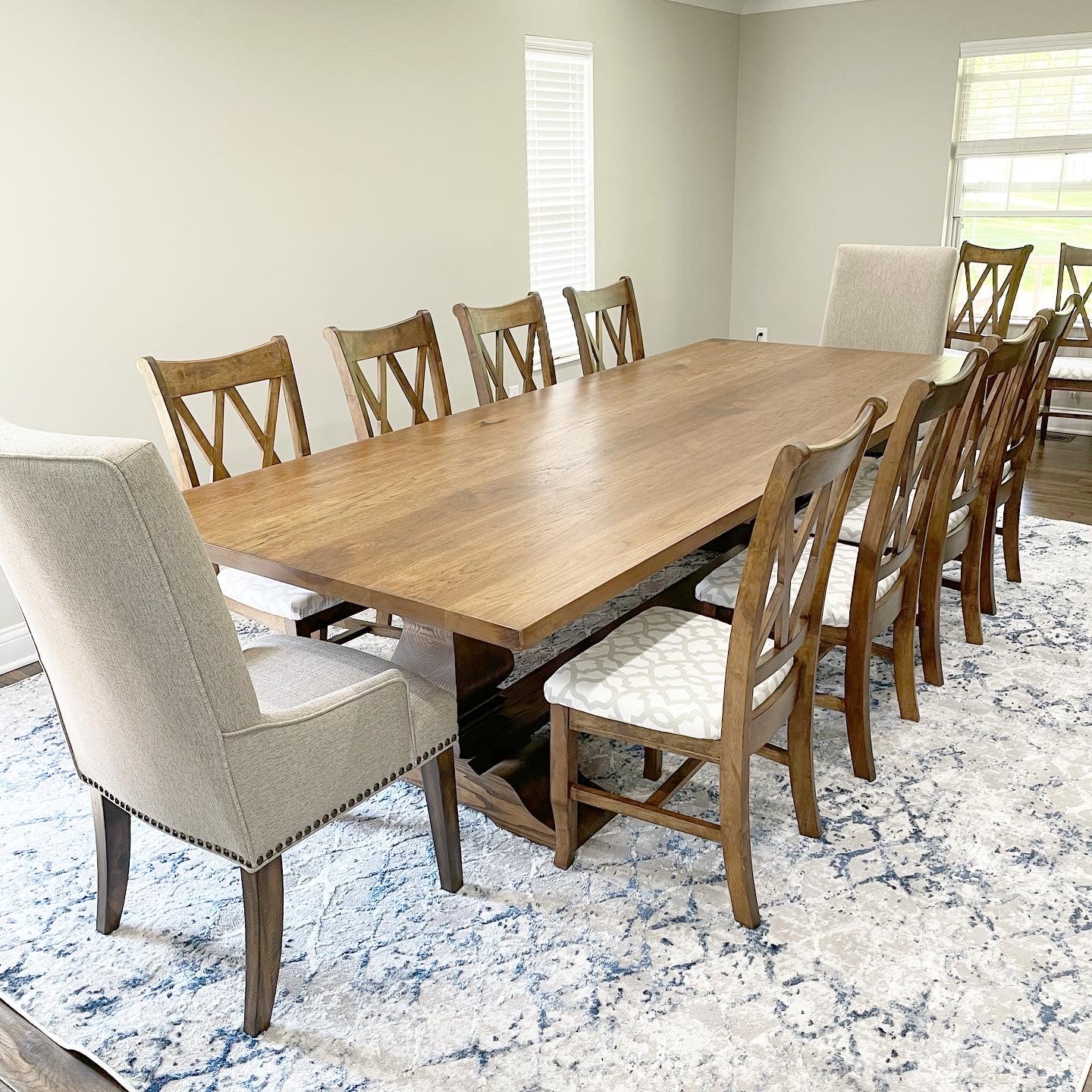 Pictured iwth a 9' L x 48" W Hickory table stained in espresso. Pictured with 8 Double Cross Back Chairs with upholstered seats with fabric provided by clinet.