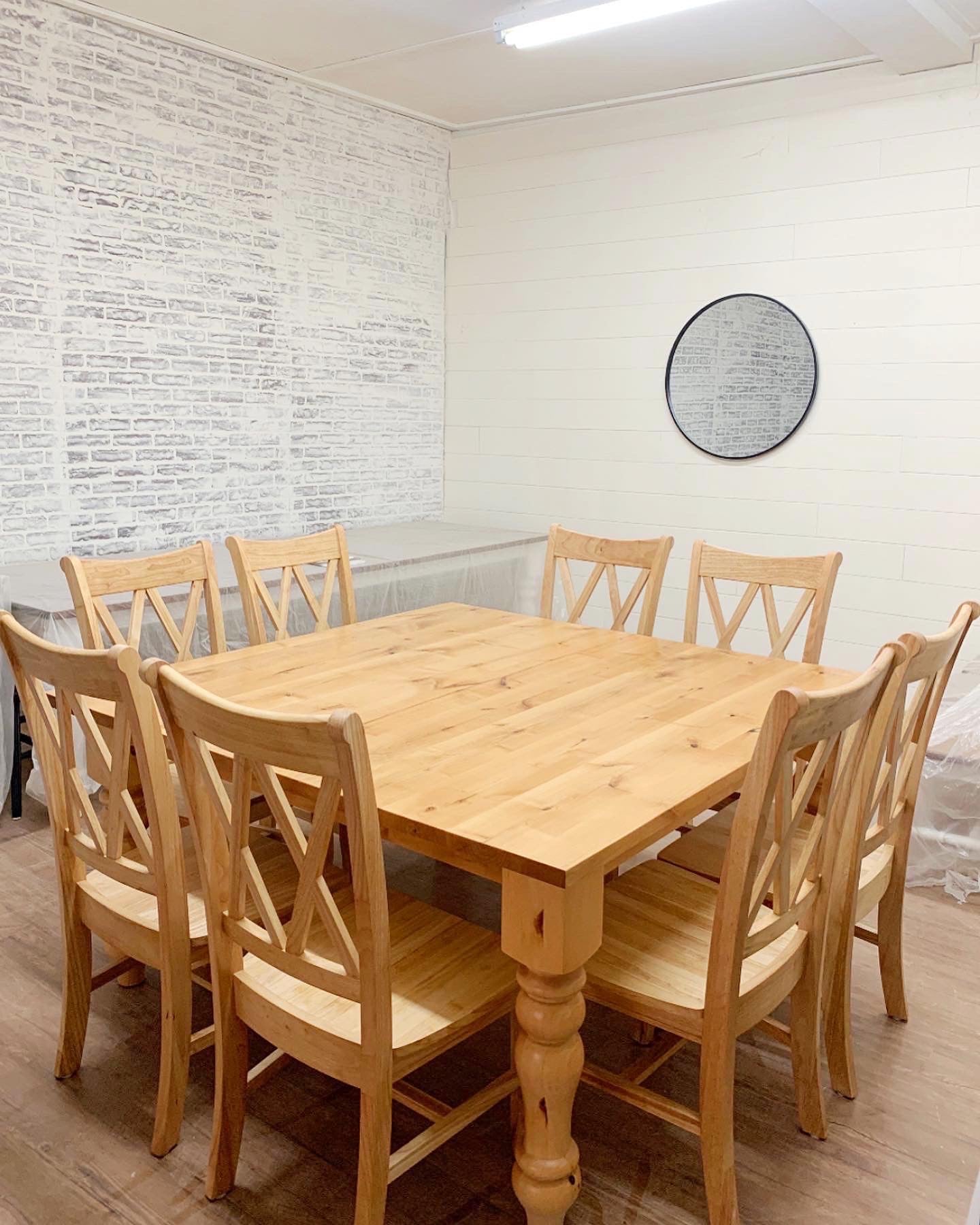 Pictured is a 60" x 60" Rustic Alder table top and Pine Legs with a Natural Finish. Pictured is 8 Double Cross Back Chairs. 