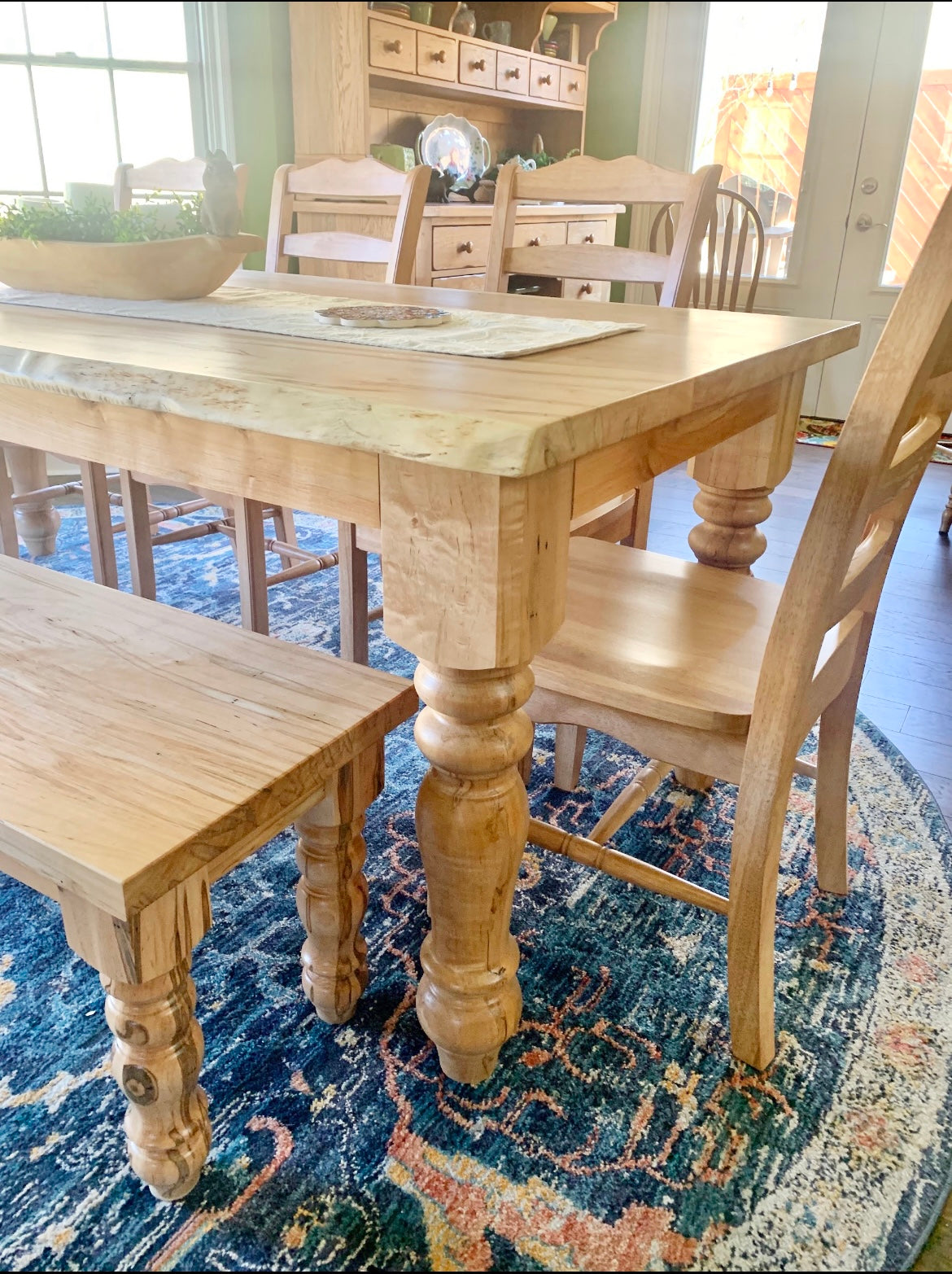 Pictured with a 7'L x 36"W Ambrosia Maple table in a Natural finish. Pictured with a Matching Bench and 5 Magnolia Chairs.