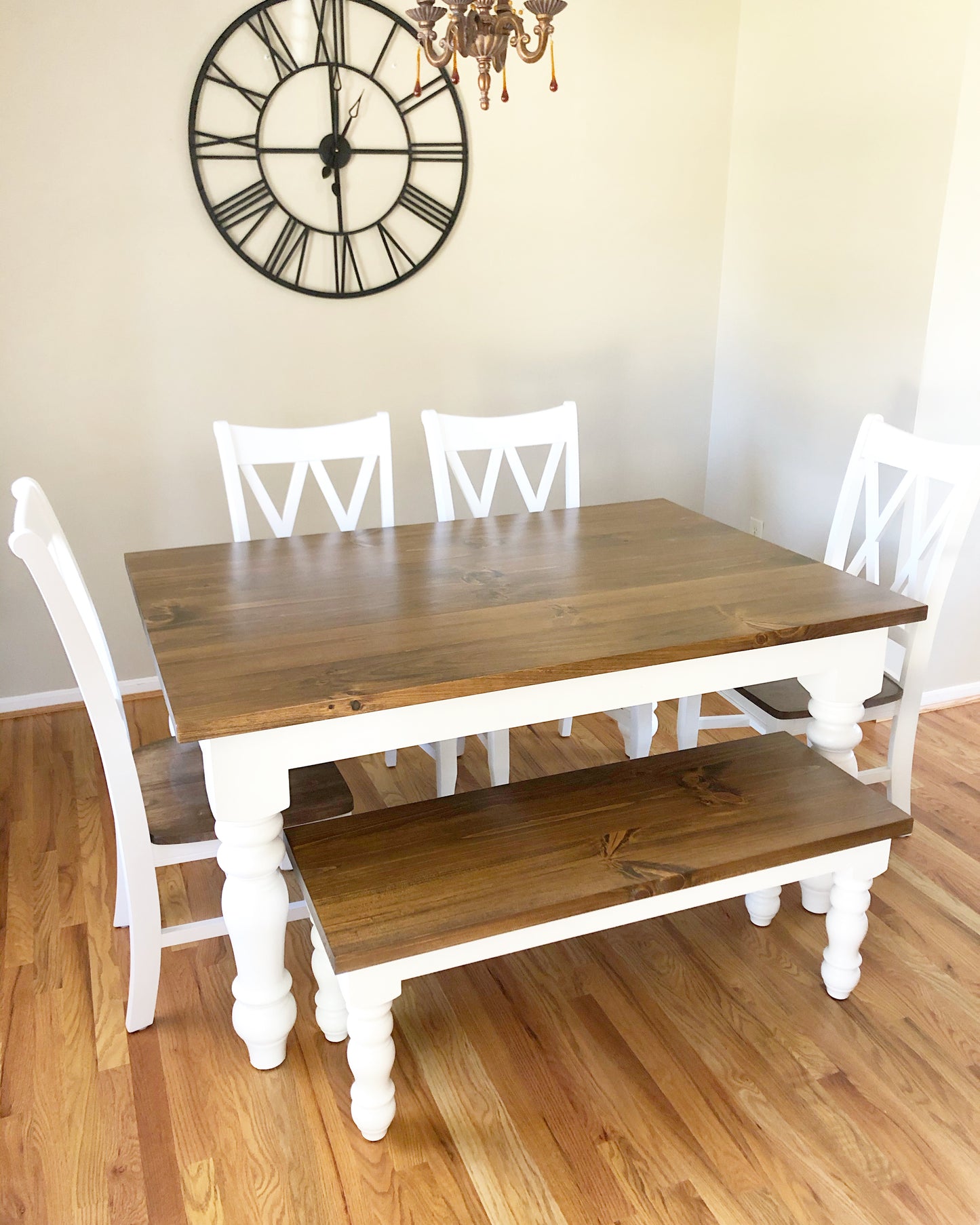 Pictured with a 5' L x 42" W Rustic Alder with Early American stain and White painted base. Pictured with a Matching Bench and 4 Double Cross Back Chairs.