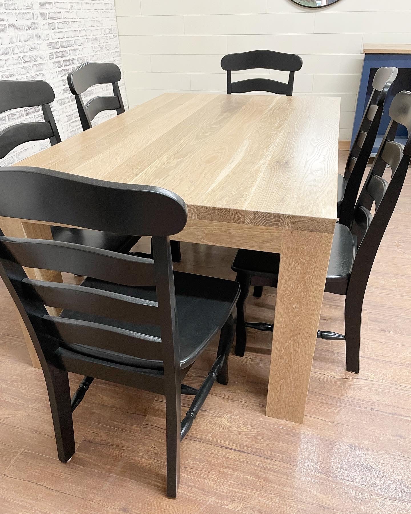 Pictured is a 5.5' L x 42" W White Oak table with Pickled Oak stain. Pictured are 6 French Country Chairs painted Black.