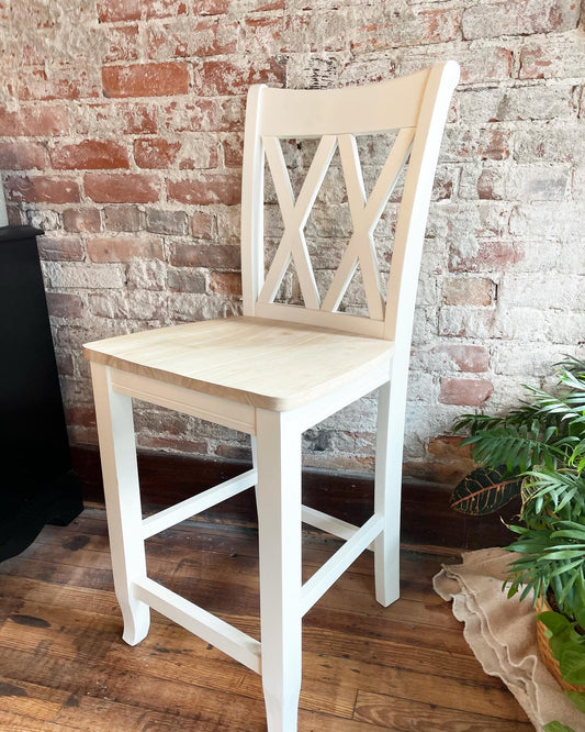 Double Cross Back Counter Height Stool painted white with a Natural finish on the seat.