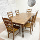 Pictured is a 7' x 42" Rustic Alder top with Pine Legs with Honey stain. Pictured with 6 Maine Ladder Back Chairs.