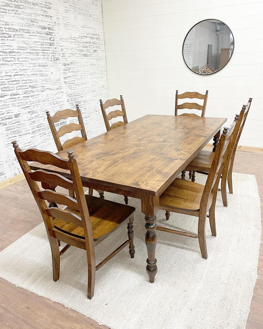Pictured is a 7' x 42" Rustic Alder top with Pine Legs with Honey stain. Pictured with 6 Maine Ladder Back Chairs.