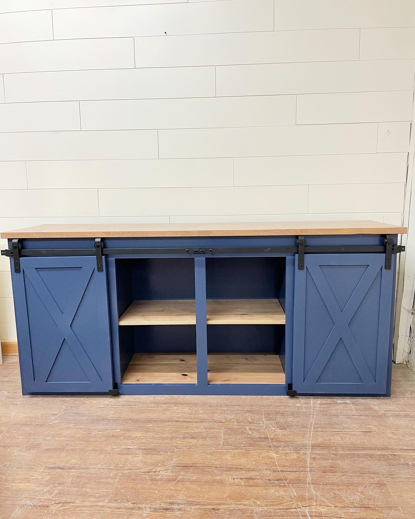 Pictured is a 72" L x 18" D x 36" T console with a Rustic Alder top and shelves with Weathered Oak Stain and Indigo Batik painted base.