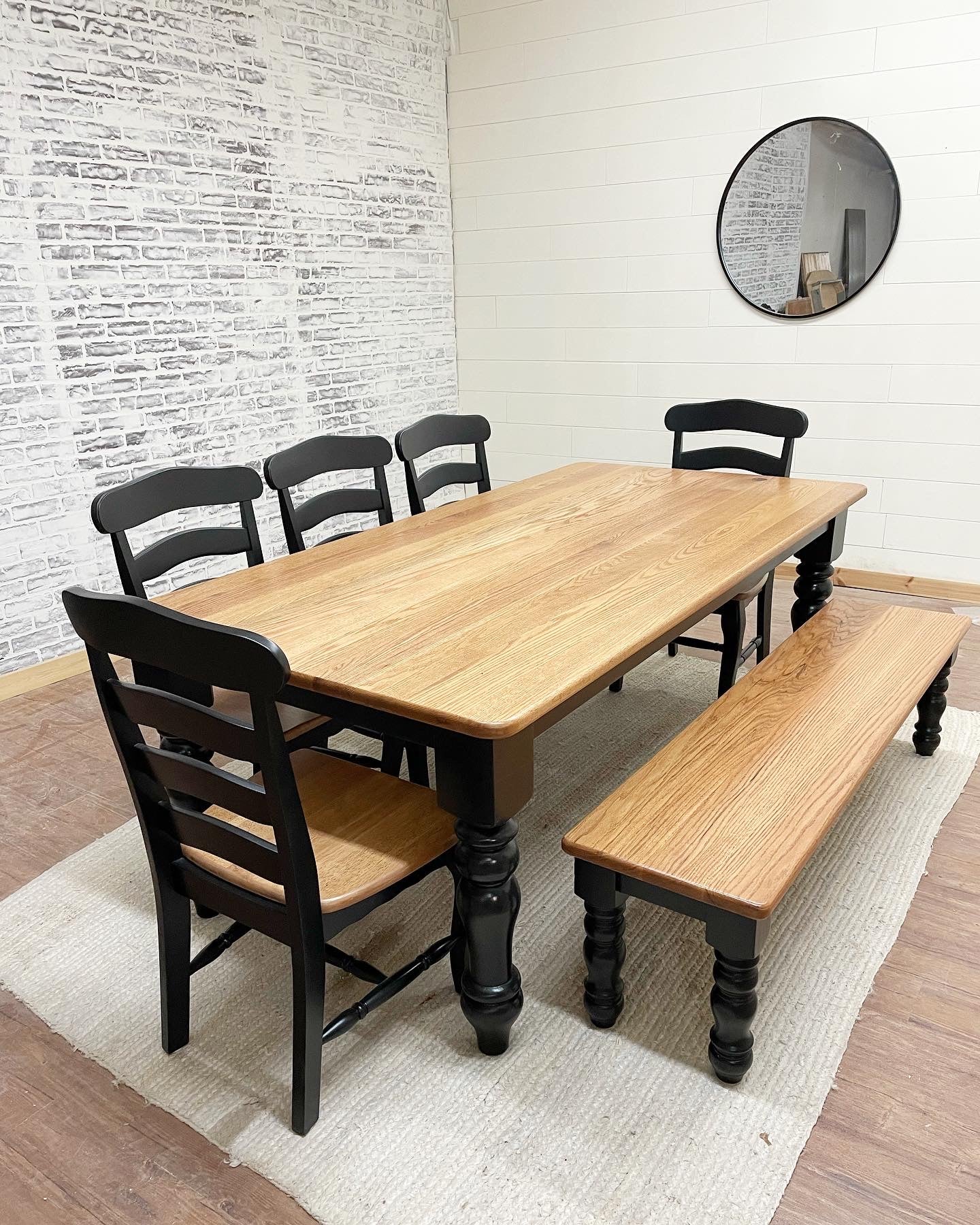 Pictured with an 8' L x 42" W Red Oak top with a Natural Finish and a painted Black base. Pictured with a Matching Bench and 5 French Country Dining Chairs.